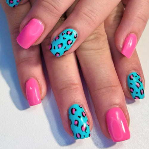 Nails with pink and blue designs on a white background