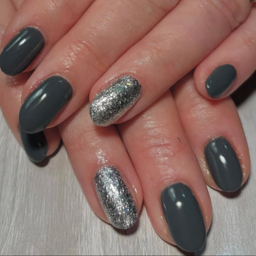 Slate grey gel polish on nail set with glitter on ring fingers 