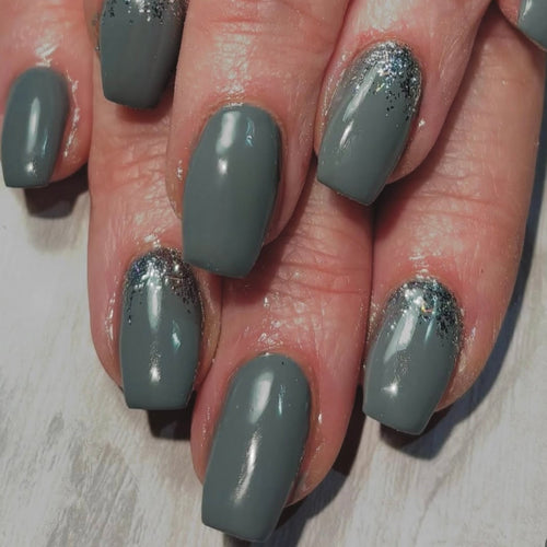 Grey nail set with glitter on a light background