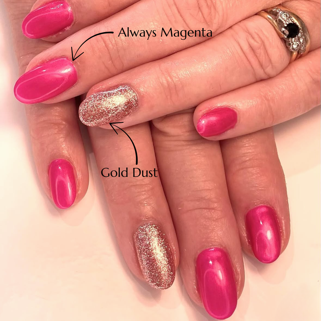 Close-up of hands with pink and gold glittery nails on a light pink background