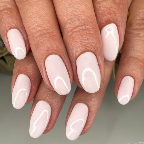 Close-up of hands with light pink nail polish on a neutral background