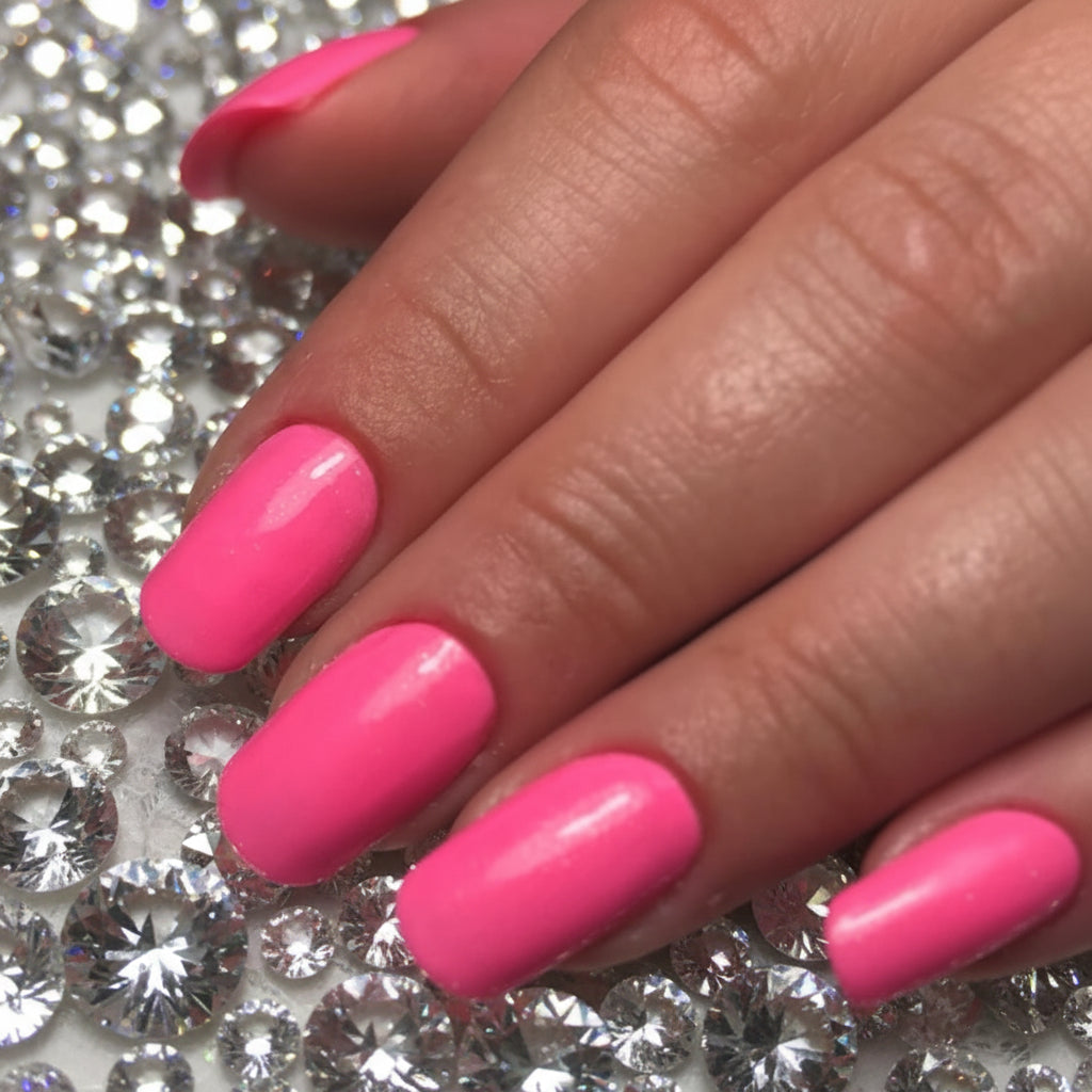 Close-up of hands with pink nail polish on a black background