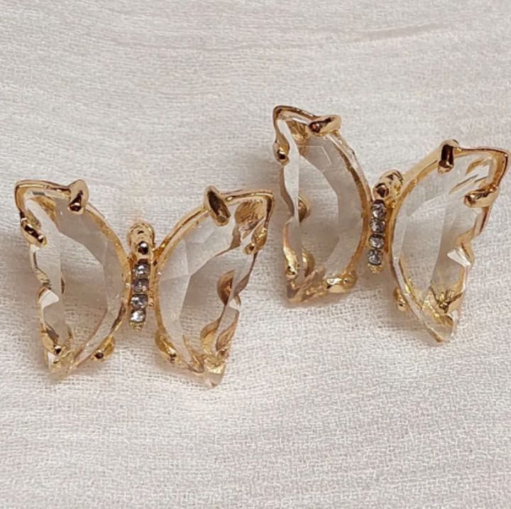 Butterfly-shaped vanilla smoke gem stones on a light background