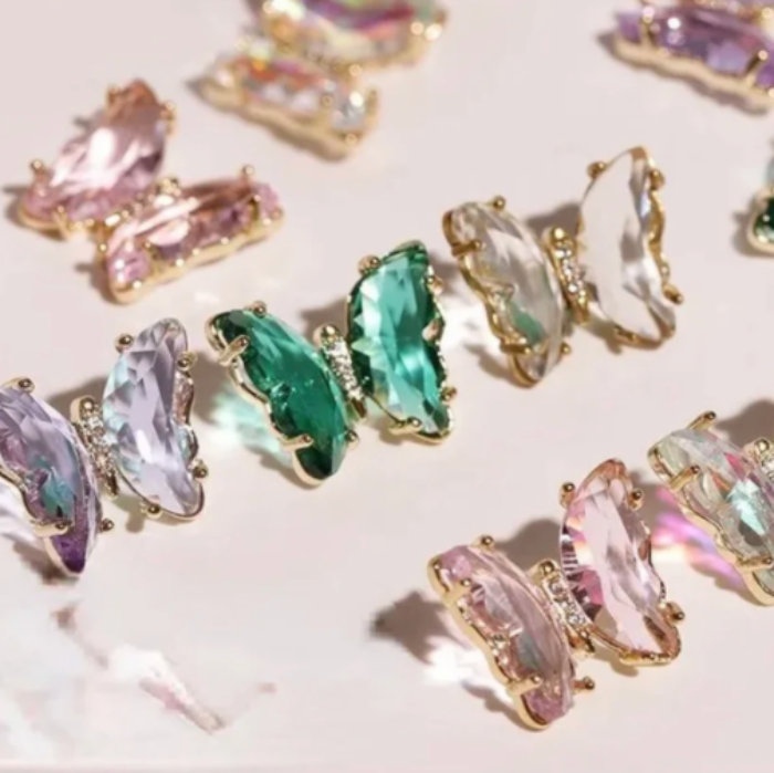 Colourful crystal nail gemstones on a light background