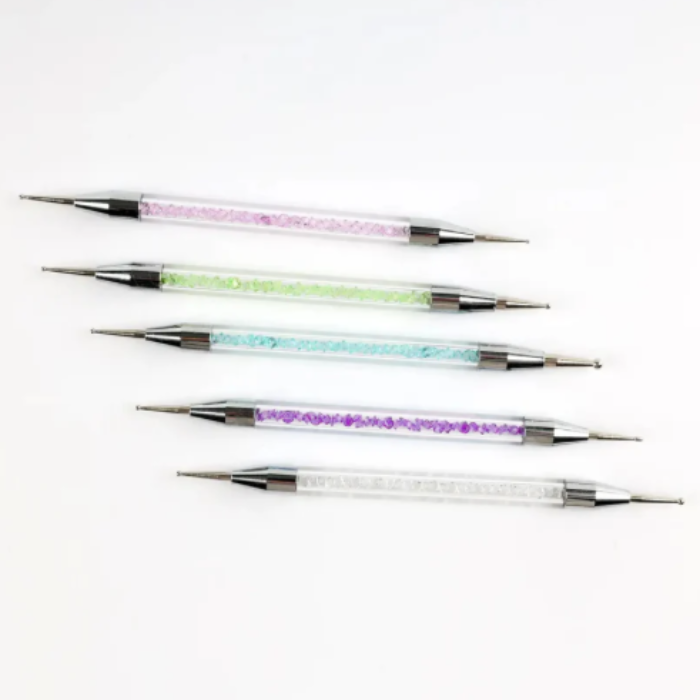 Set of five nail art dotting tools with colorful glittery tips on a white background