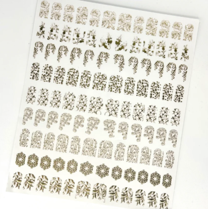Sheet of gold decorative stickers with various patterns on a white background