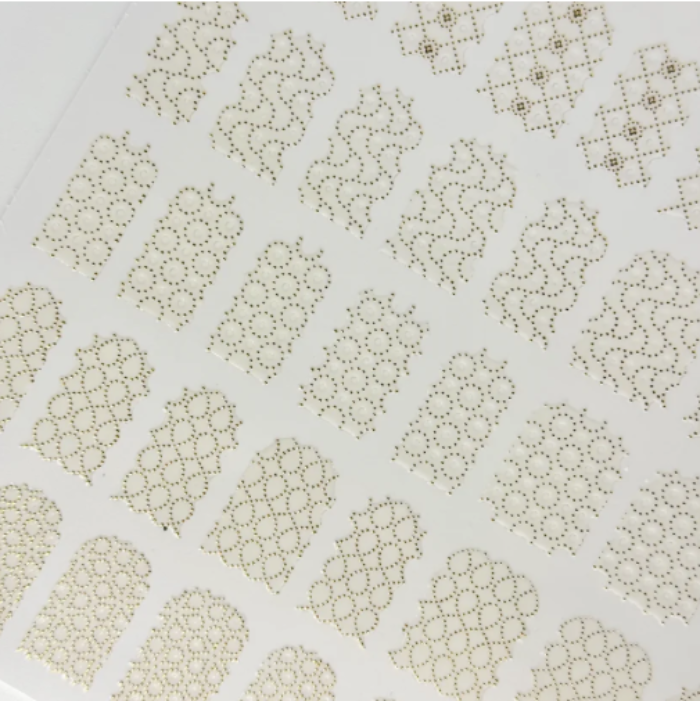 Patterned nail stickers with geometric shapes on a white background
