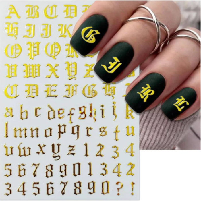 Black nails with gold lettering and a sheet of gold letters and numbers.