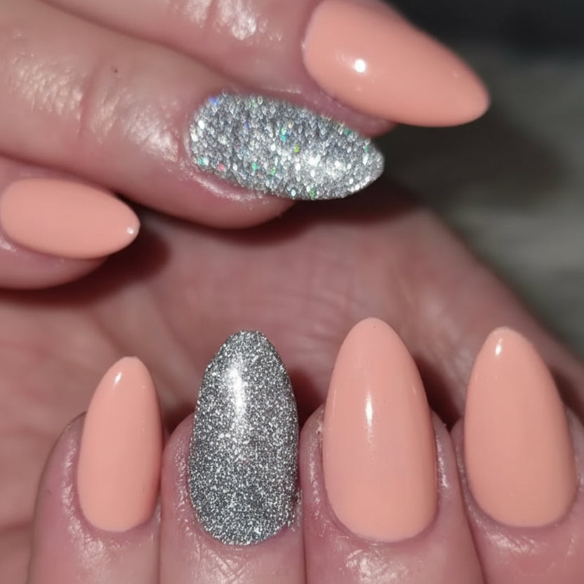 Nail set with a peach colour and shimmery silver
