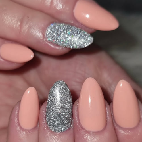 Nail set with a peach colour and shimmery silver