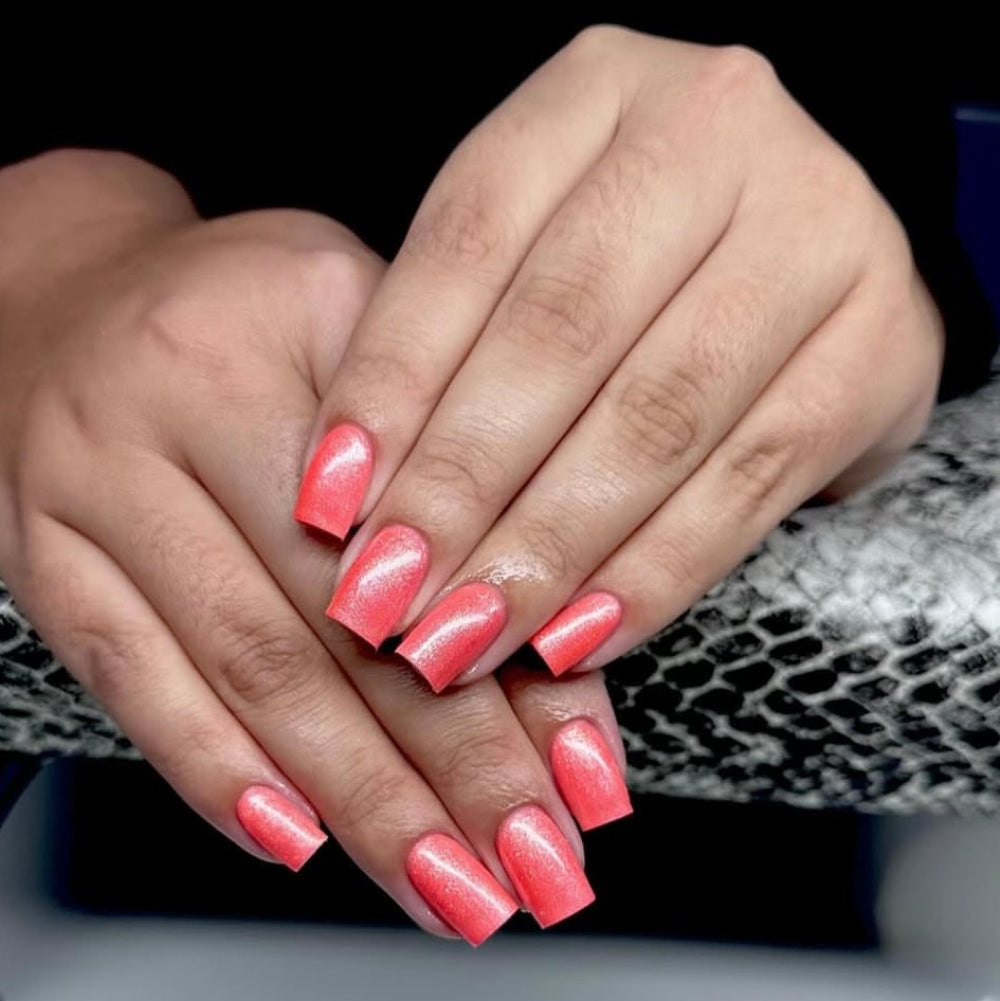 Close up of hands with shimmery peachy nails 