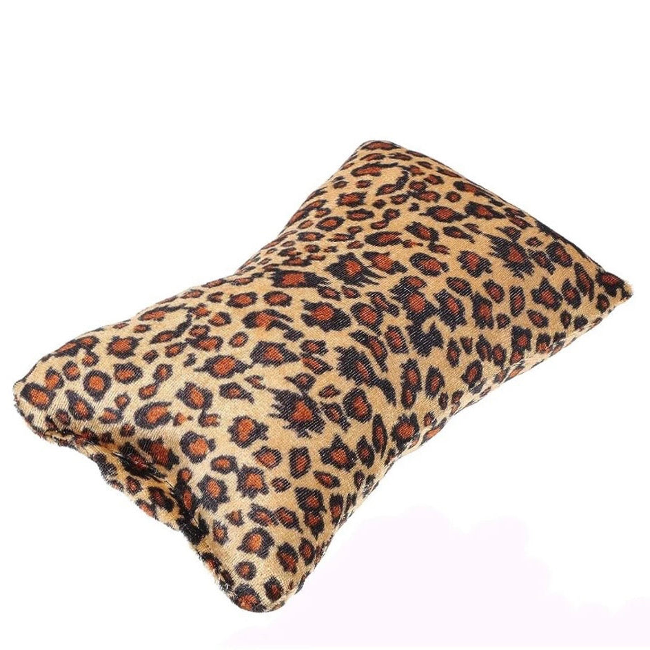 Natural leopard print nail pillow on a white background 