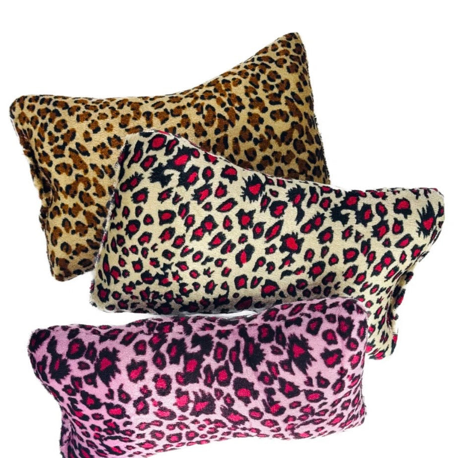 Three leopard print pillows in different colours on a white background for nails