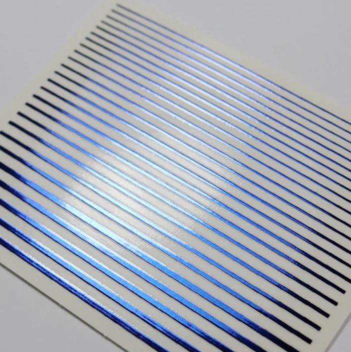Nail art metallic blue horizontal lines on a white background