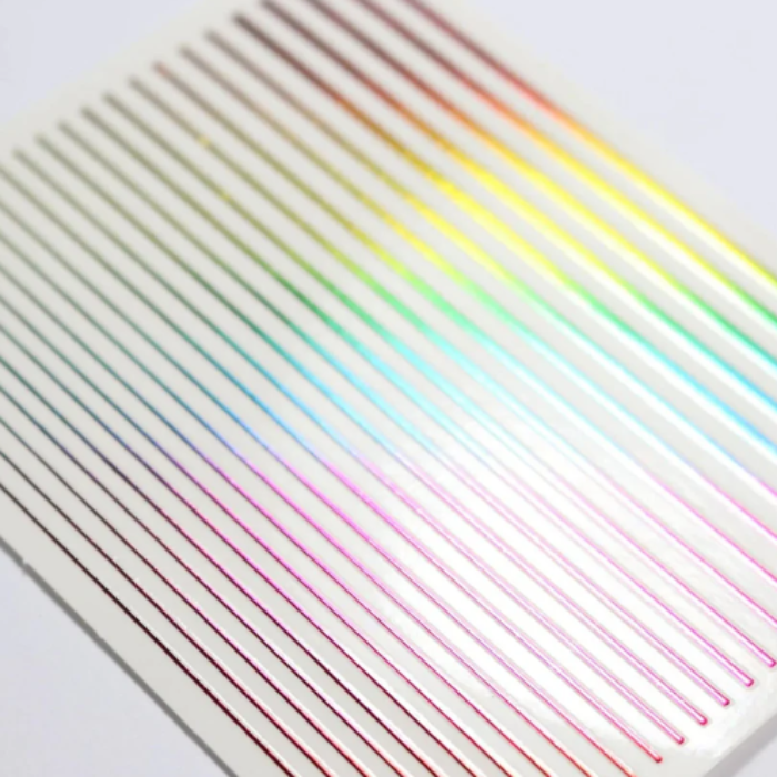 Set of colourful nail art stripes arranged in a gradient on a white background