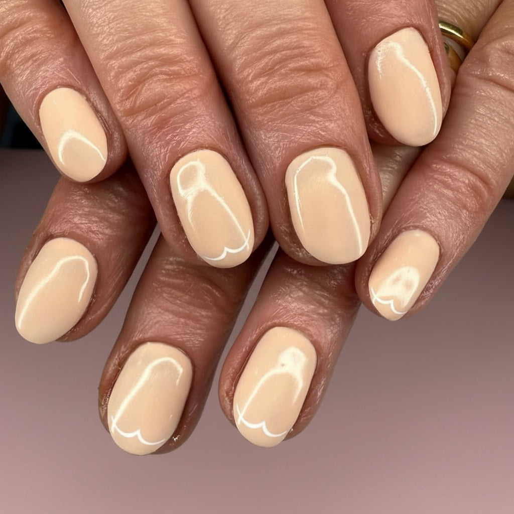 Close-up of hands with beige nail polish on a neutral background
