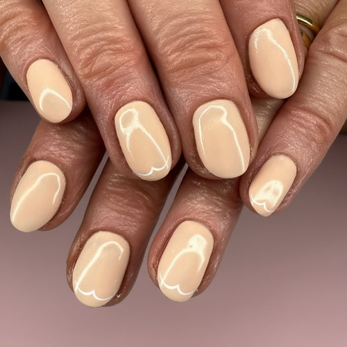 Close-up of hands with beige nail polish on a neutral background