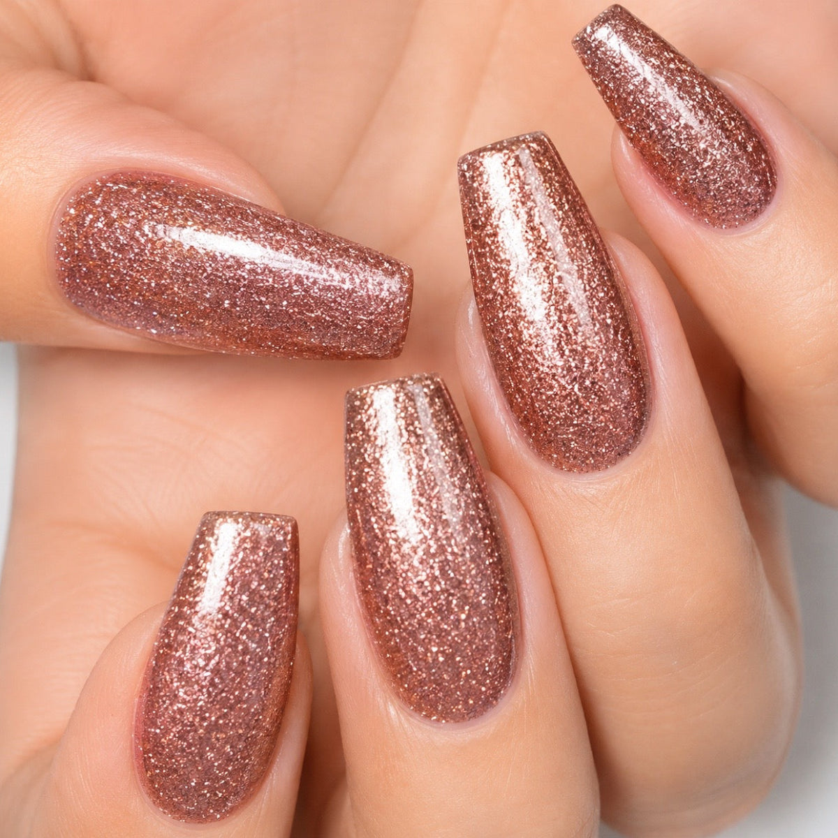 A nail set featuring a sparkly gold gel polish 