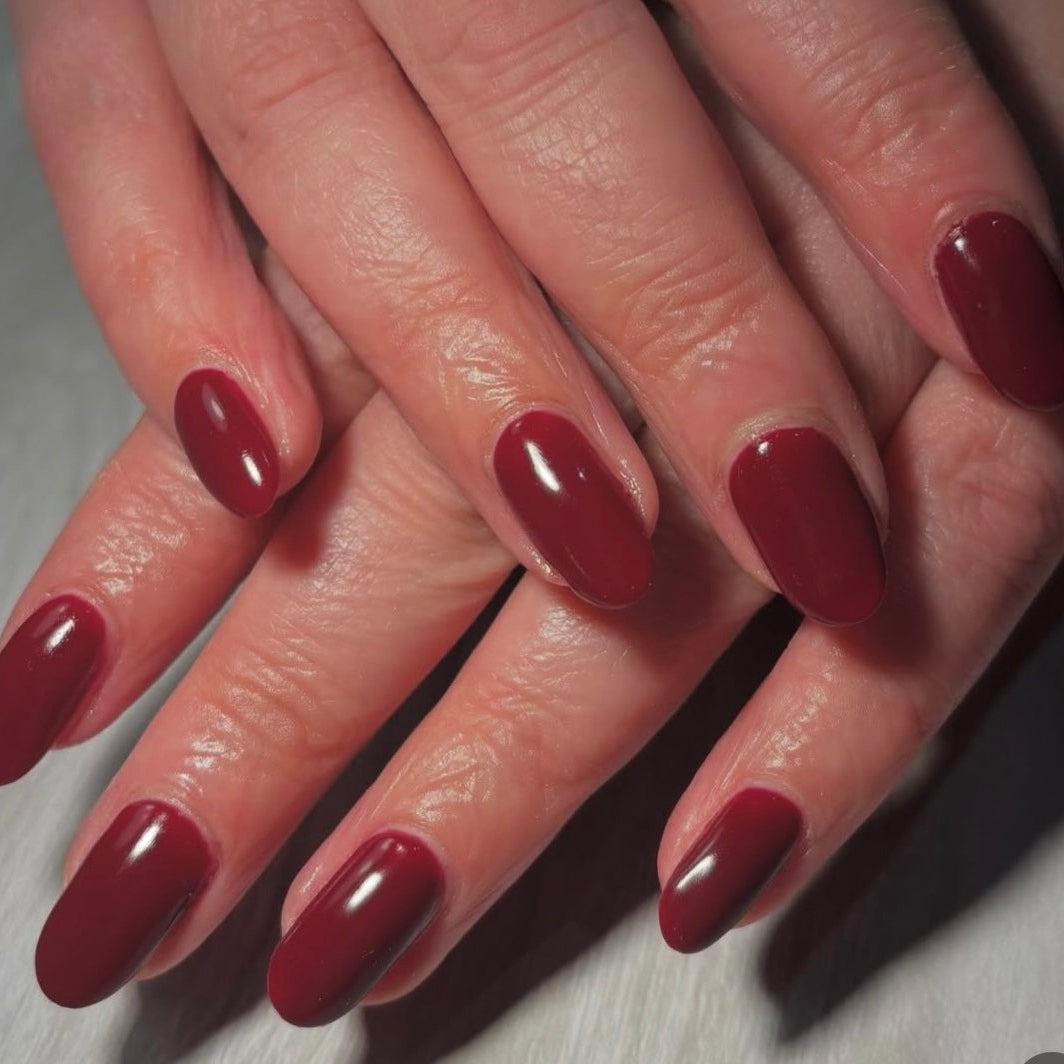 Set of deep red nails on a light background 