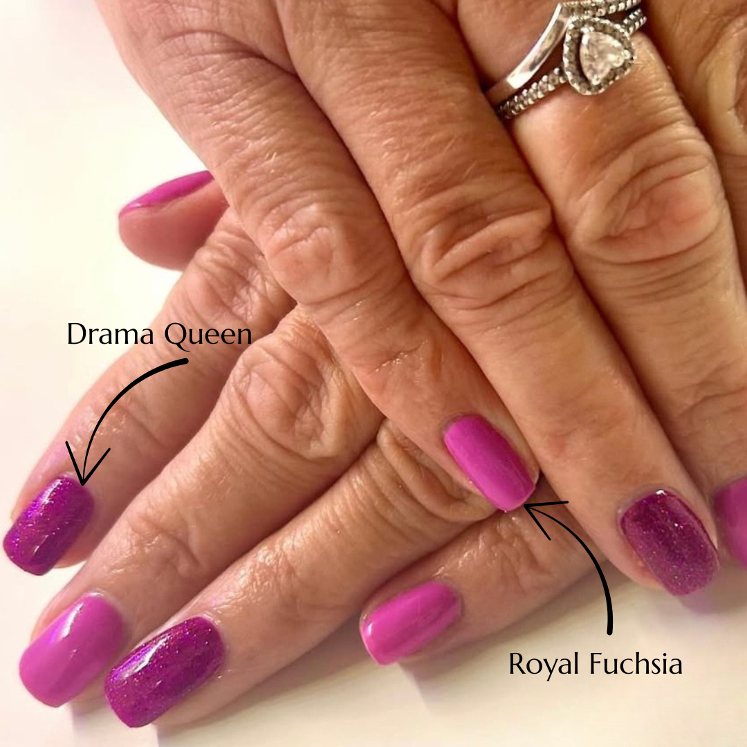 Close-up of hands with purple glittery nail polish labelled 'Drama Queen' and 'Royal Fuchsia'.