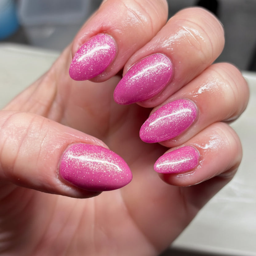 Hand with pink glittery nails 
