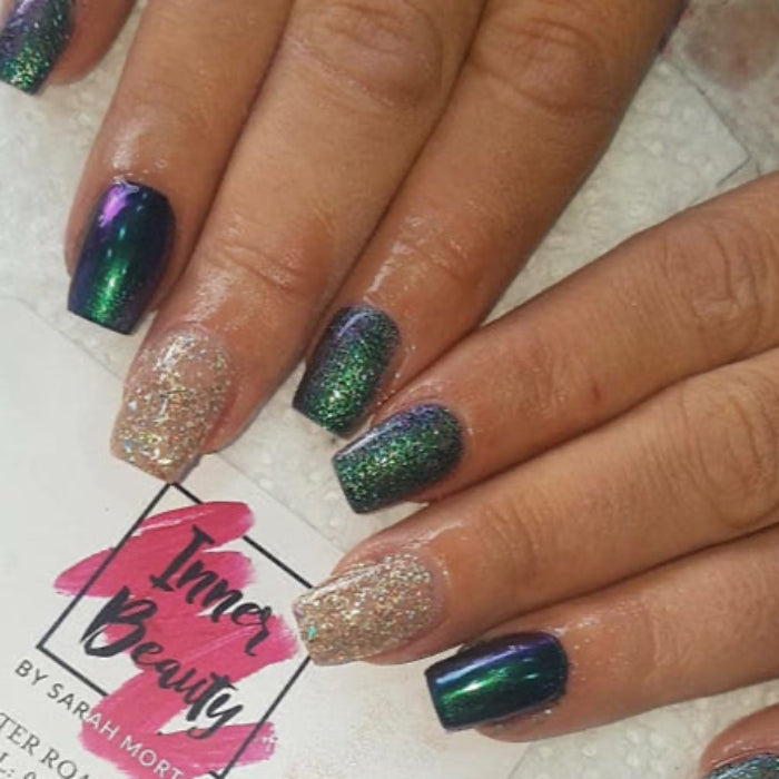 Nails with glittery green and purple design on a white background with 'Inner Beauty' branding.