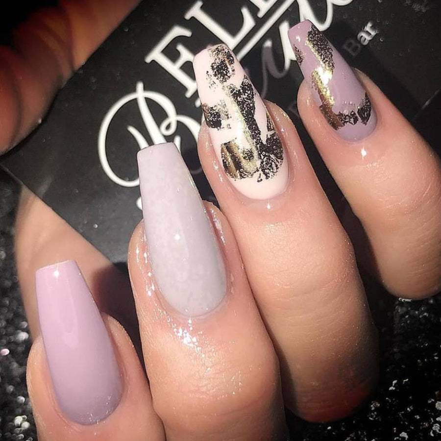 A hand with nails painted in a pale grey-pink colour 