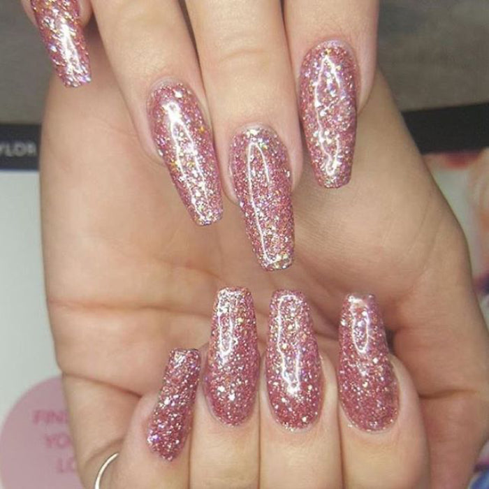 A set of nails featuring a glittery pink 