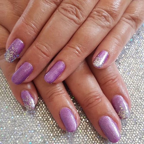 Purple gel polish on nails with glitter 